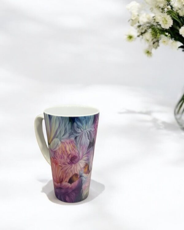 Elegant tall latte mug with a floral design featuring an original painting by Elis.Artworks, in soft pastel tones, standing on a white background with delicate flowers in the background.